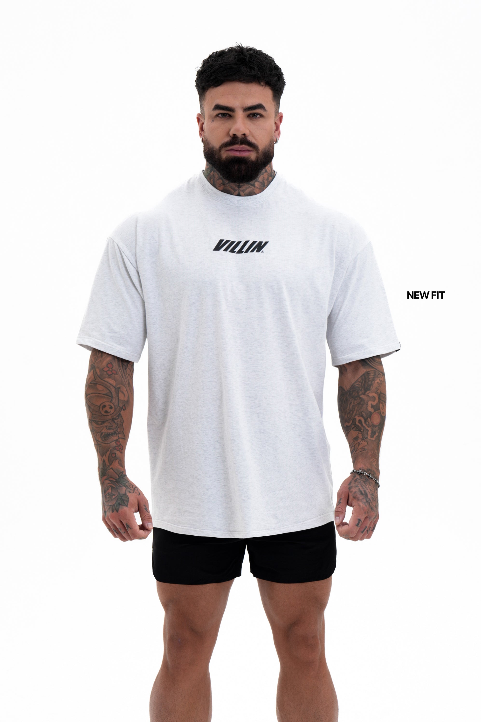 Man wearing a white t-shirt with 'Villain' branding on a white background