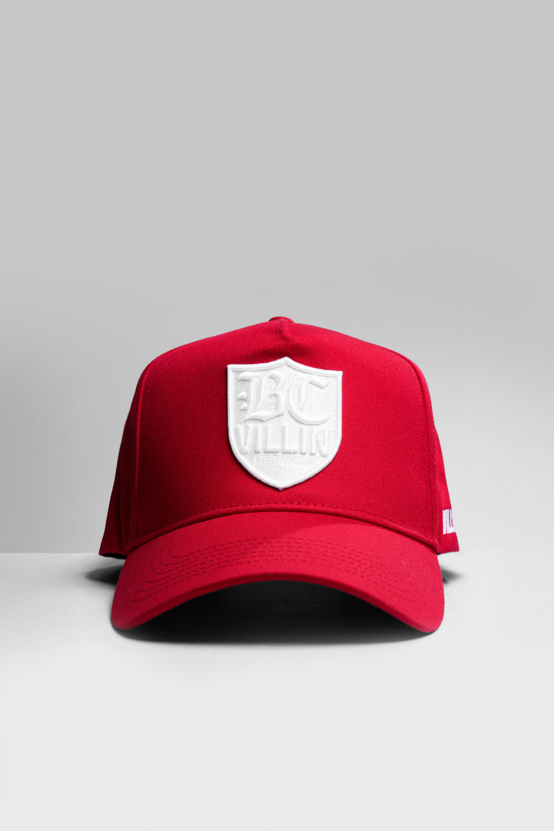 Red VILLIN cap with a white logo on a gray background