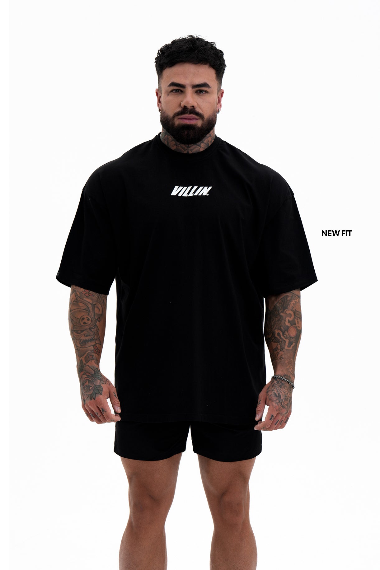 Man wearing a black t-shirt with 'VILLIN' branding on a white background